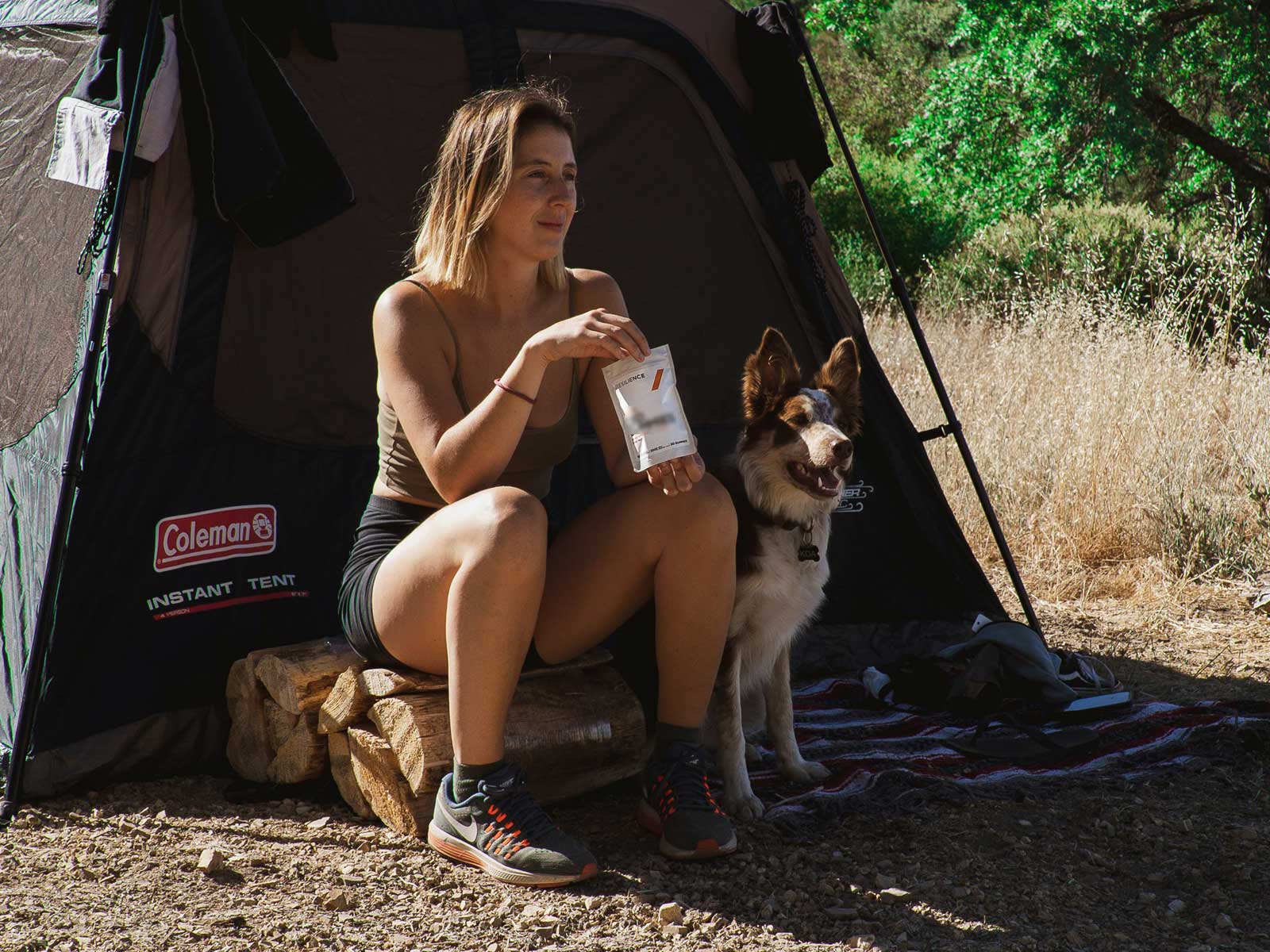 Girl camping with a dog