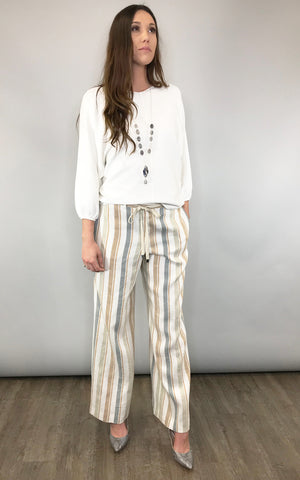 Soft stripes in loose linen are chic and feminine
