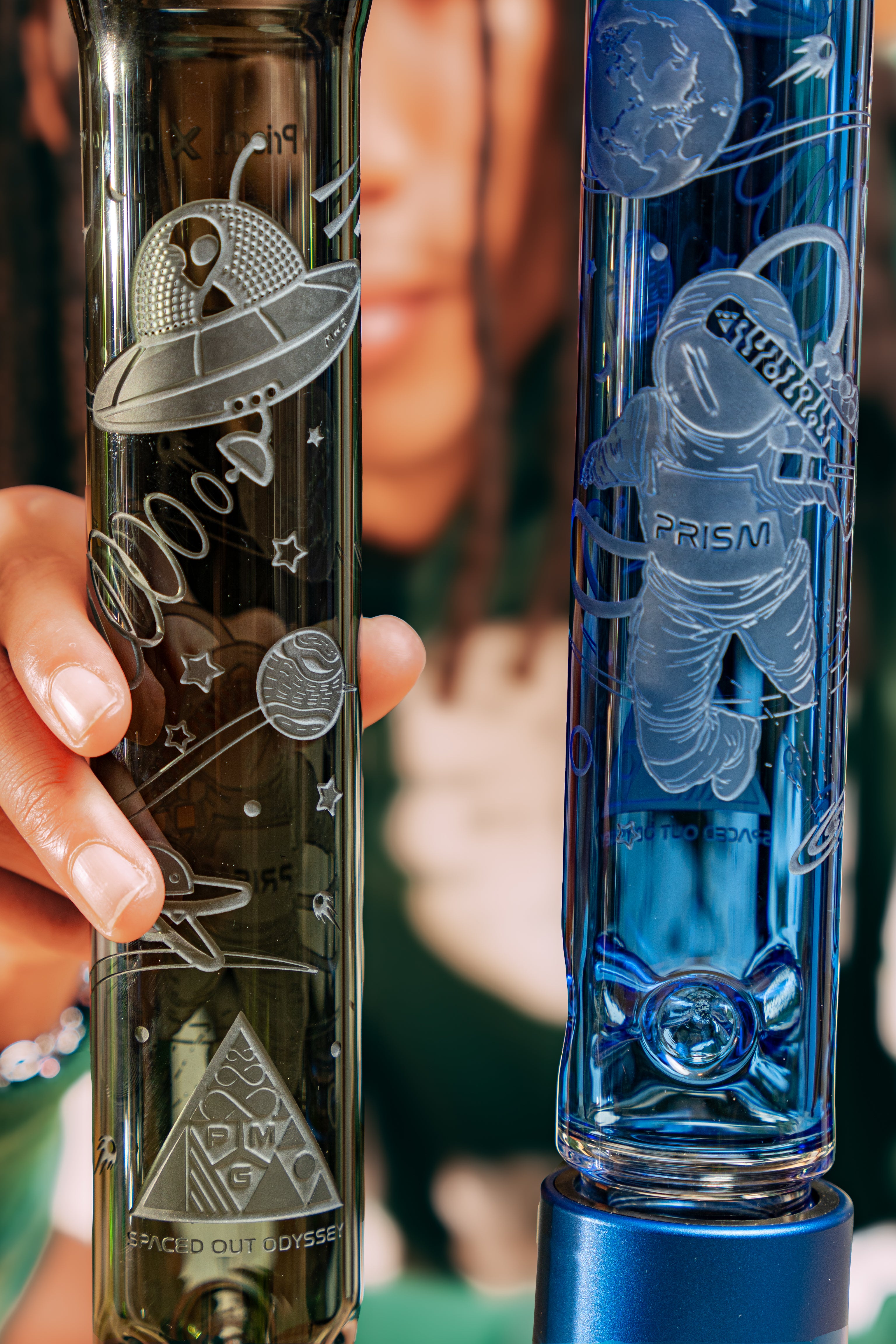 Decorative glass bottles with engraved space-themed designs.