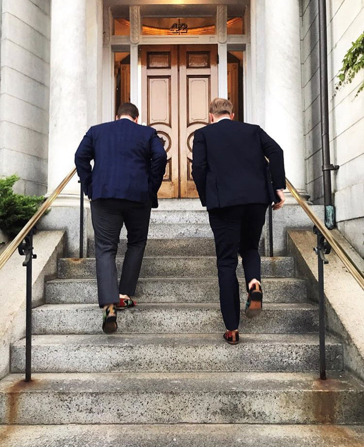 groomsmen running up the stairs in the chapel while wearing mens kilim loafers