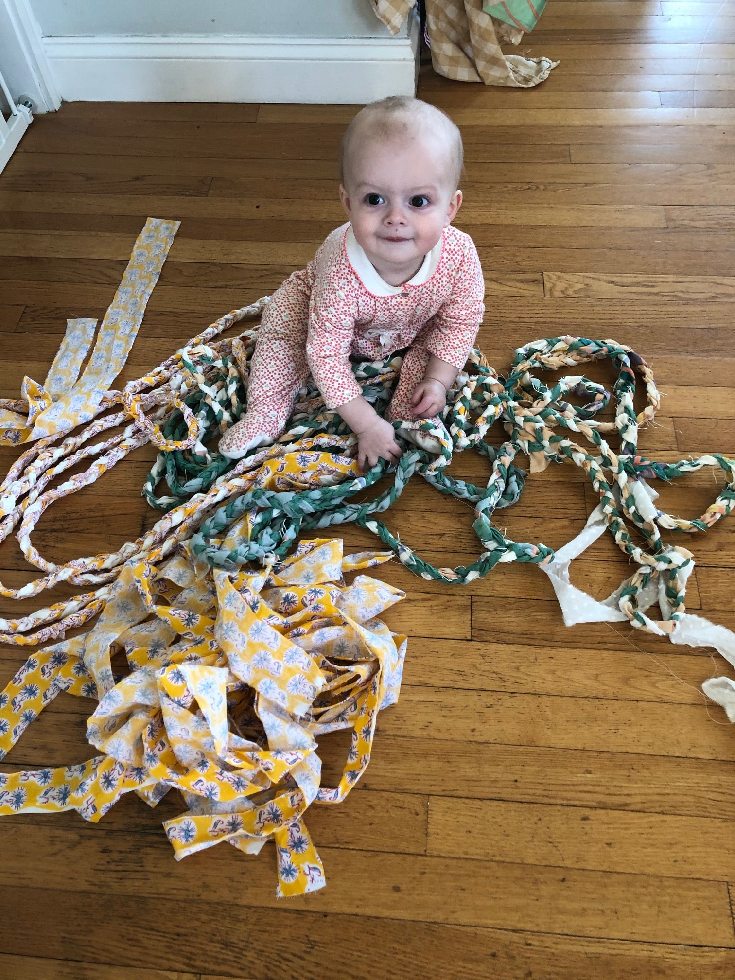 baby with rag rug braid