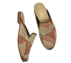 A pair of soft red and beige Women's Kilim Slippers on a white background