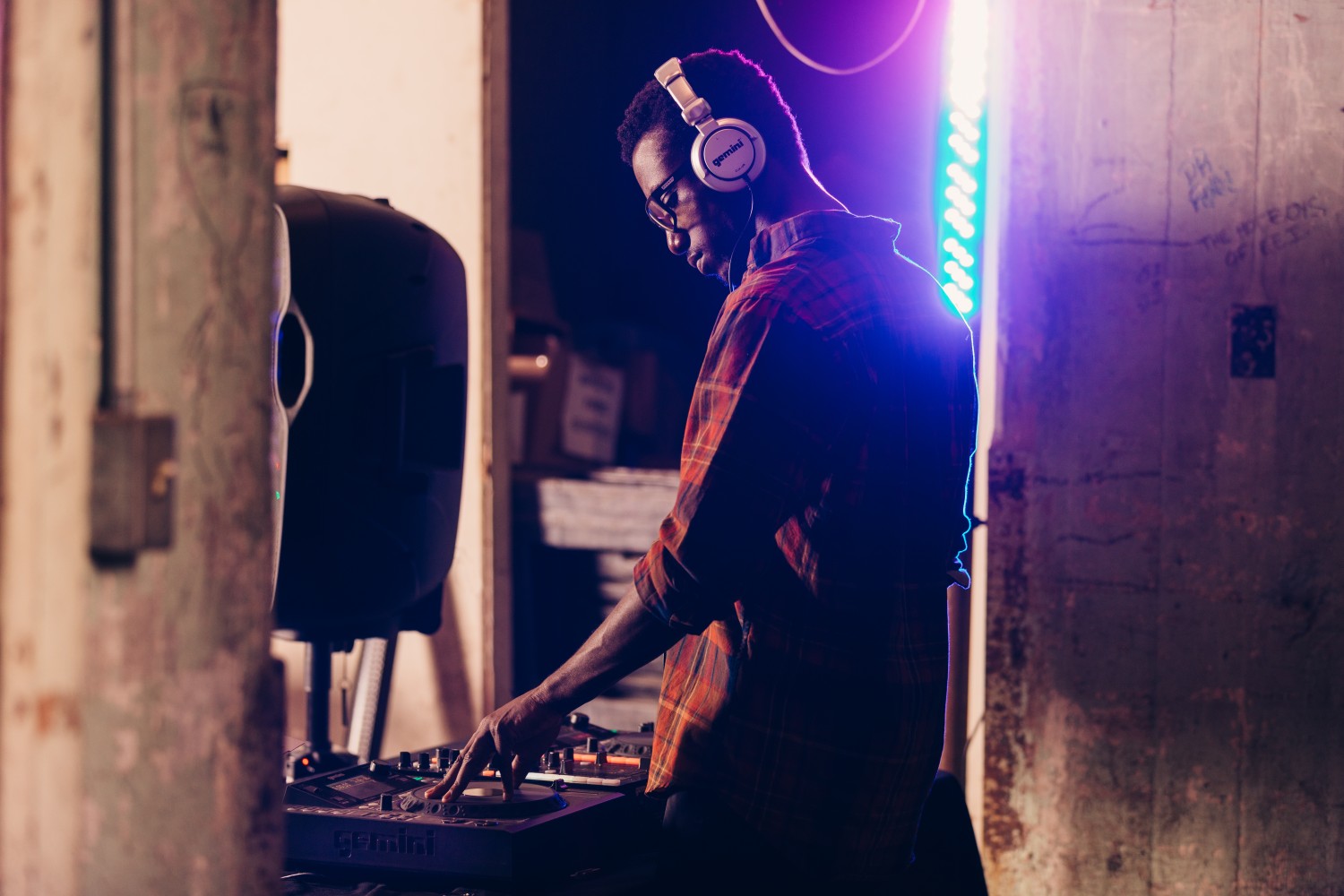 Man wearing headphones using a turntable