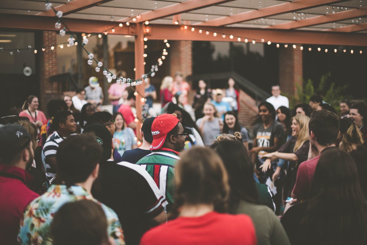 crowd of people at a backyard party