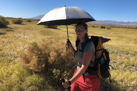 hiking with an umbrella in the hot sun