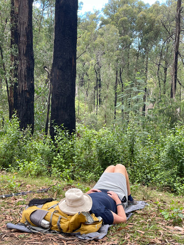 laying down and resting on a hike