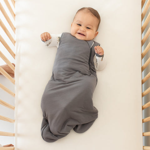 smiling baby wearing a kyte baby sleep bag