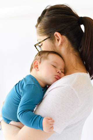 How can I get my newborn sleeping more at night?