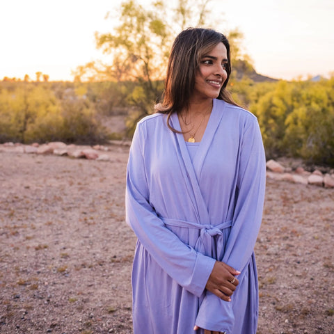 mom wearing a kyte baby lounge robe in taro