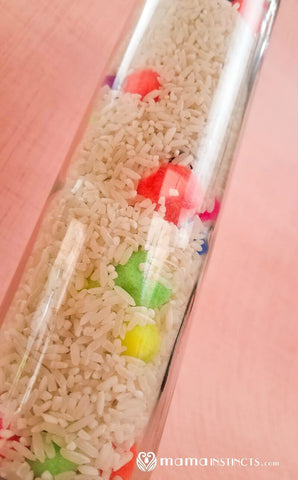 a sensory bottle made from an empty water bottle and rice