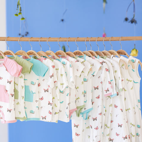 kyte baby spring prints clothes hanging on a rack