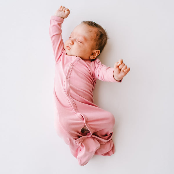 newborn in kyte baby bundler stretching