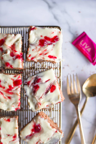 Top down view of gluten-free blondies on a baking rack with LIVA Date Sugar pouch next to it.