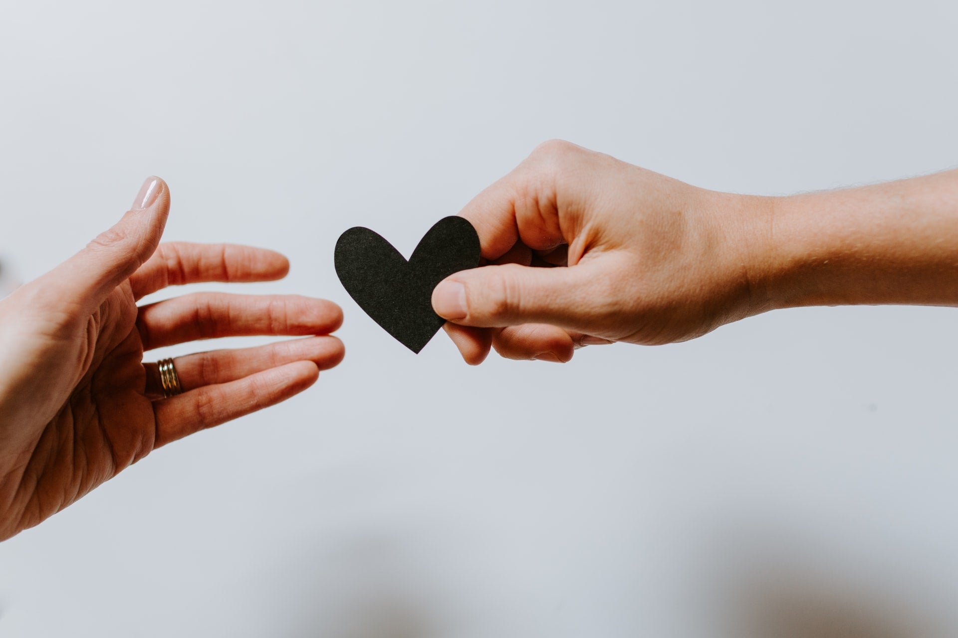 hands holding a paper heart