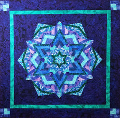 Kaleidoscopic quilt in blues, purples and greens