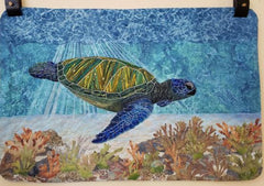 Quilt featuring a sea turtle under water.