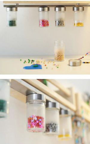 Under cabinet storage featuring small bottles of brightly colored beads