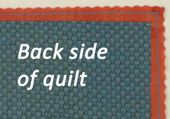 back side of quilt showing the scalloped binding strip