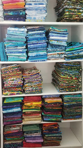 colorful quilting fabric folded neatly on shelves