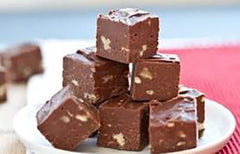 Cubes of chocolate fudge stacked on a plate