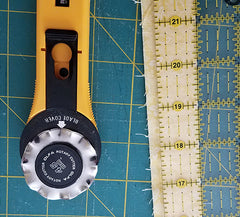 image shows the binding strip and a rotary cutter with a scallop edge