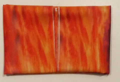 Orange fabric folded to a small size so that all raw edges are in the center.