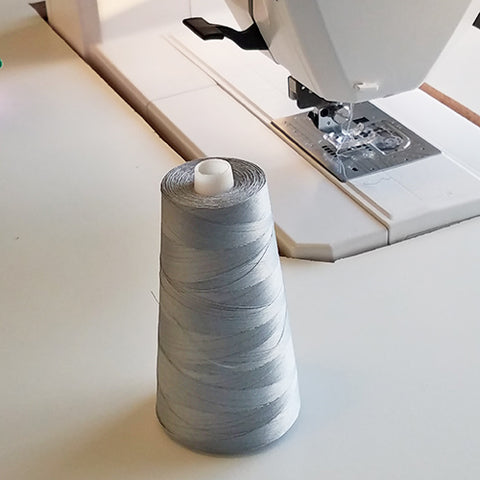 Large cone of gray thread new a sewing machine