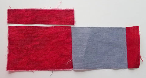 Scrap fabric pieces (squares and rectangles) are sewn together.