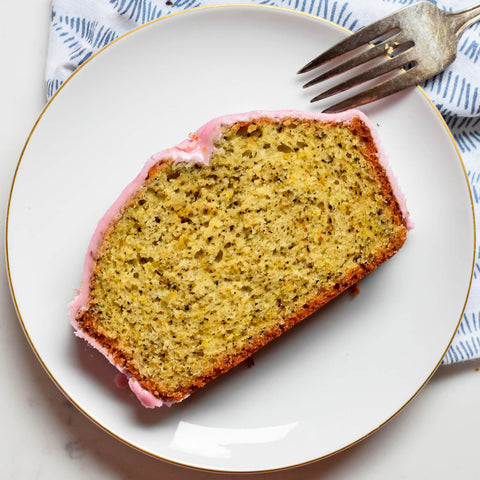 slice on plate of earl grey loaf cake with pink icing