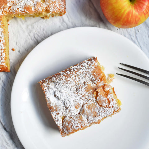 french apple cake square from overhead, dusted with powdered sugar