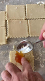 rolled dough being cut 2