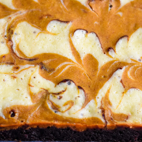 Close up view of top of pumpkin cream cheese swirl brownies