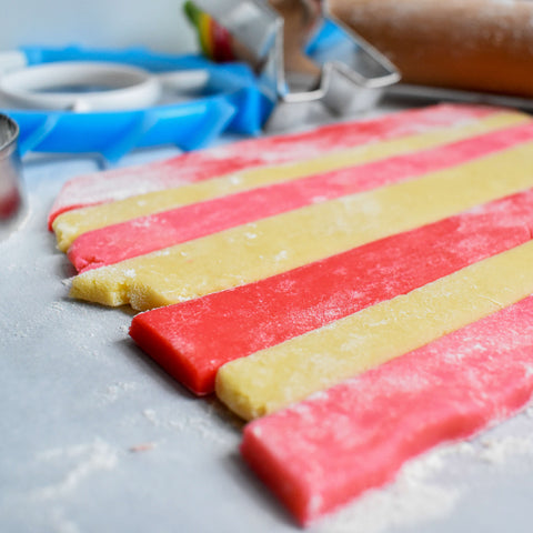 three colors of dough rolled to form stripes