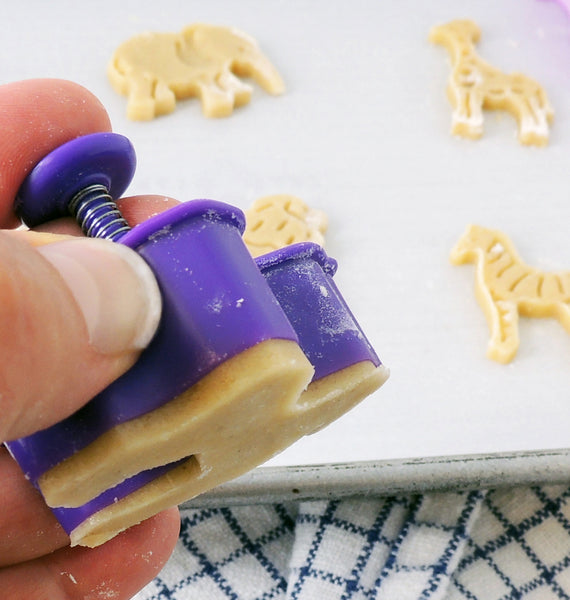 MIni animal cookie cutter in use, shows plunger mechanism
