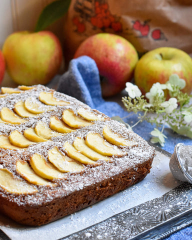 Whole applesauce cake studded with sliced apples