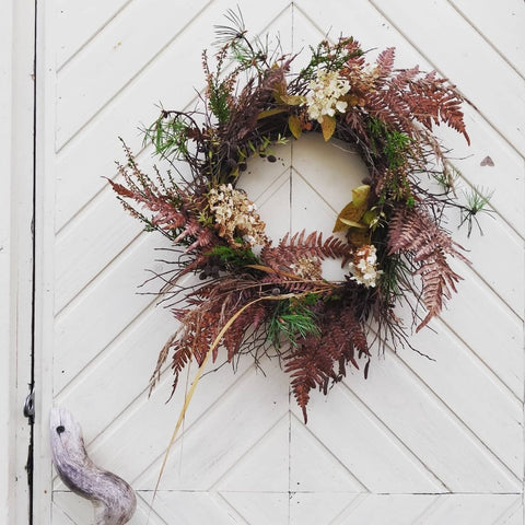 A wreath made of wild plants and dried flowers.