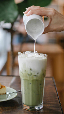 matcha latte with ice cubes in it