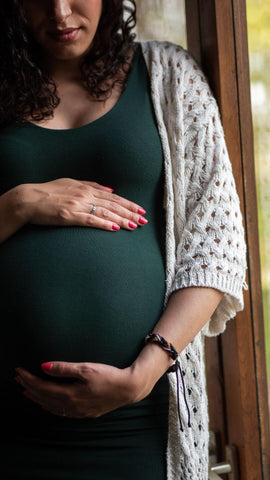 pregnant woman holding her baily