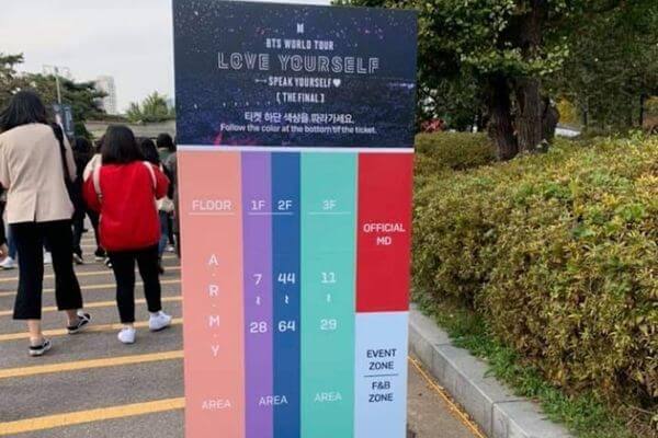 A sign outside of the Jamsil Olympic Stadium showing the colored paths to follow to get to various spaces around the stadium for the BTS World Tour Love Yourself Speak Yourself The Final concerts. 