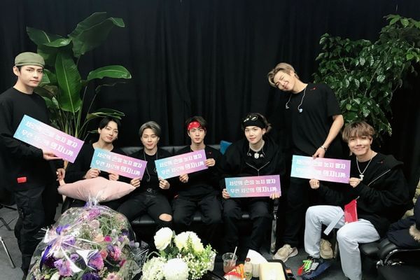 BTS at the back stage of their Love Yourself Speak Yourself concert holding slogans