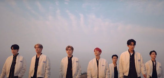 ENHYPEN members in white jackes walking in Future Perfect MV