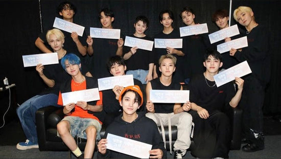 seventeen members holding concert signages