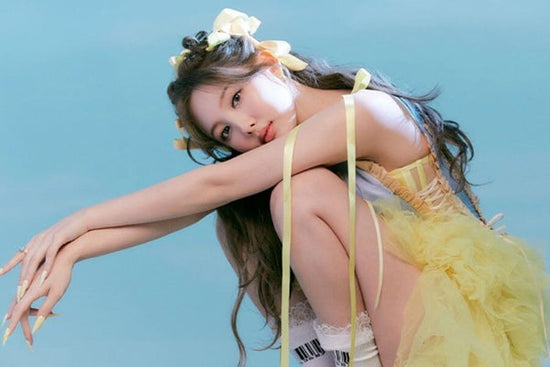 Nayeon in a yellow dress for a picture in the IM NAYEON album