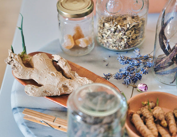 fresh ginger and dried flowers in clear jars