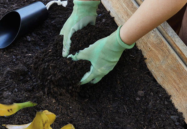laying compost in a garden bed