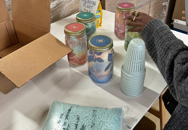 a woman's hands packing the parts for the Modern Sprout Garden Jars