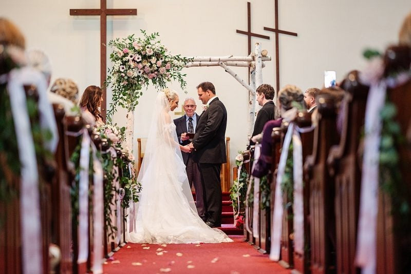 Bride and Groom at the Altar for Spring Inspired Wedding The Garter Girl