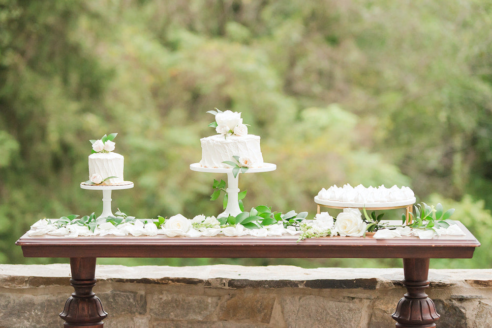 white wedding cakes on cake table with tips for planning wedding during holidays - The Garter Girl