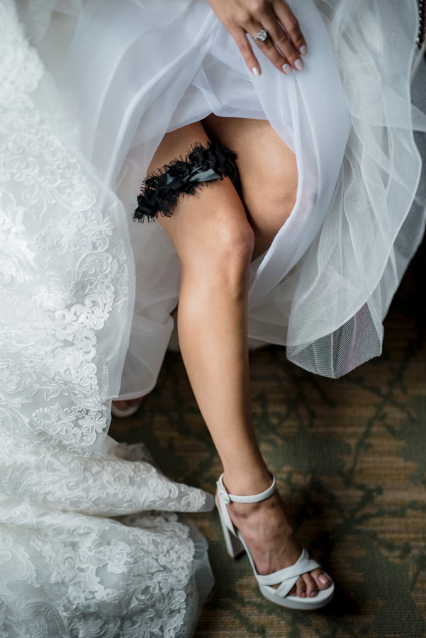 Black Wedding Garter on Bride's Leg with Gown