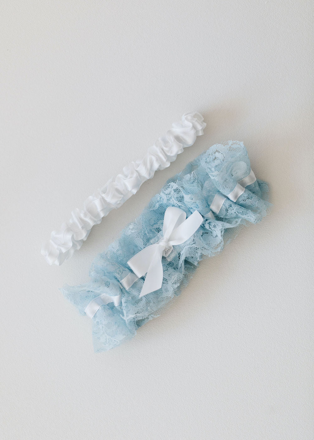custom wedding garter set handmade with blue lace and white satin by expert bridal accessory designer, The Garter Girl